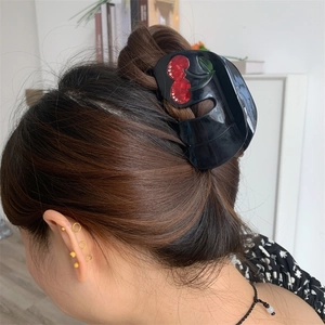 Elegant black hair claw clip featuring a 3D cherry design with sparkling rhinestones