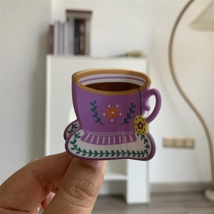 Detailed macro view of a purple floral acrylic tea cup hair claw clip for women