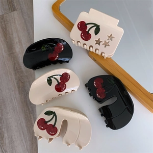 Elegant acetate cherry hair claw clips in black and white with sparkling rhinestones