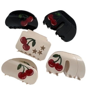 Minimalist cherry acetate hair claws set with rhinestones and star cutouts on white base