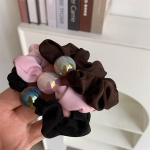 Three-piece large hair scrunchies set in pink, brown, and black with holographic beads