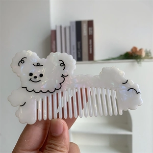 Detail of cute cartoon dog hair comb made of thick iridescent acetate material