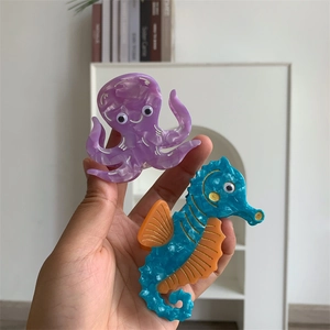 Detailed view of handmade acetate sea animal hair claws featuring octopus and seahorse designs