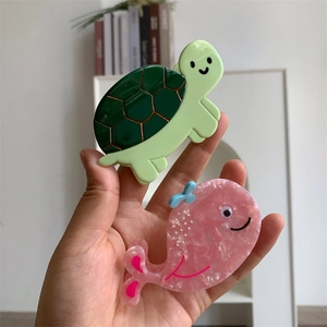 Sea animal acetate hair claws with turtle and whale designs for half-tie hairstyles