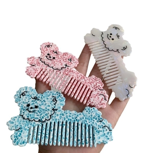 Three cute cartoon dog acetate hair combs in white, pink and blue marbled patterns