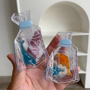 Close-up of creative acetate hair clips with ocean creatures in fish bag design