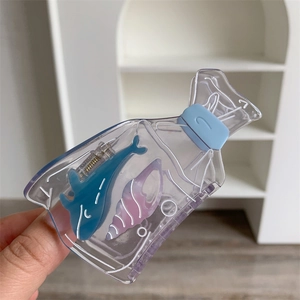 Detail view of transparent acrylic shark hair claw clip with colorful ocean elements inside