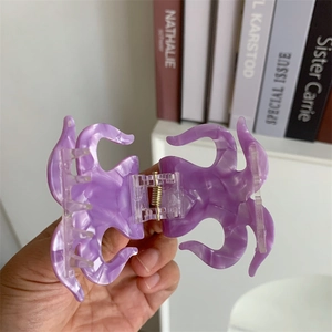 Detail view of purple marbled acetate claw clip with octopus tentacle design and metal spring