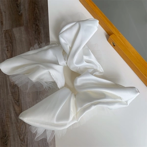 Detailed view of white satin and mesh scrunchie featuring elegant lace edges and textures