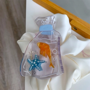 Close-up of acetic acid hair claw clip with goldfish and starfish in water bag design