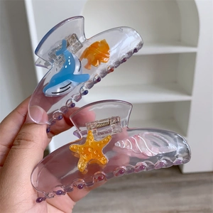 Transparent purple ocean-themed hair claw clips with whale and starfish relief