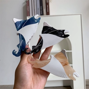 Detail showing marble texture acetate stingray hair claw clips in three colors