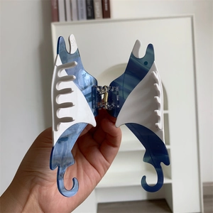 Detailed view of ocean-inspired stingray hair claw clip with blue marble pattern