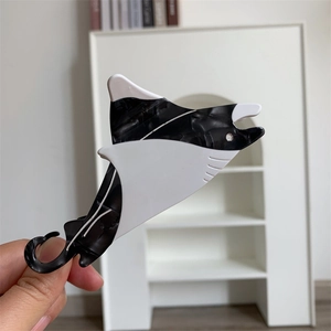 Macro view of marbled black and white acetate manta ray hair claw clip