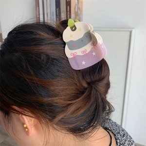 Birthday cake hair claw with purple base, cream top, and pink bow decoration