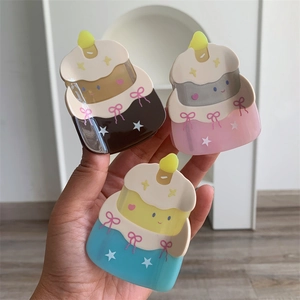 Detailed view of three cake-shaped acetate hair claws with sweet bows in various colors