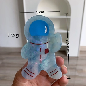 Pince à cheveux astronaute en acétate bleu translucide avec paillettes et dimensions