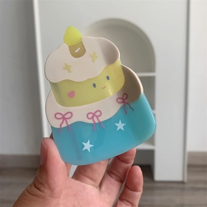 Detail view of a 3-layer cake acetate hair claw with pink bow and star patterns