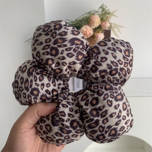 Detailed view of large leopard print velvet scrunchie with soft fabric texture