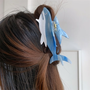 Detailed blue and white shark-shaped hair claw clip for thick hair styling