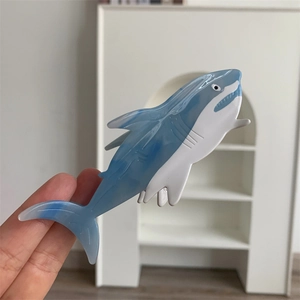 Detail of blue and white marble acetate shark hair claw clip with nautical design