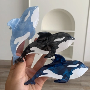 Orca shaped acetate hair claws set with marble ocean textures for women's hair styling