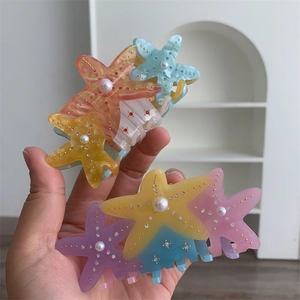 Colorful starfish hair claws with pearls and rhinestones in various macaron shades
