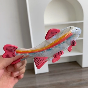 Pink fish shaped hair claw clip made of acetate with pearl texture for half-up hairstyles