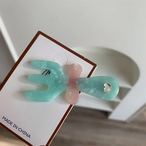 Fermaglio per capelli a forcina verde marmorizzato con fiocco rosa e strass a cuore