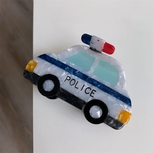 Detailed macro view of police car shaped acetate hair claw clip with clear text