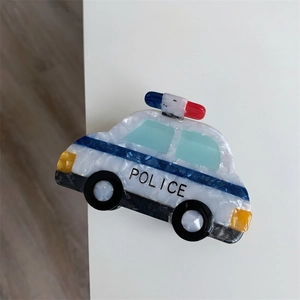 Detail view of acetate police car hair claw clip with blue stripes and POLICE text