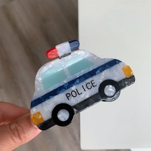 Macro detail of a police car shaped acetate hair claw clip with glossy pearlescent finish