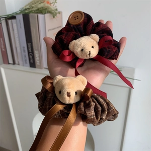 Set of two plaid scrunchies with plush bear heads and wooden button details