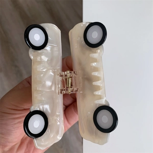 Detail showing the inner metal spring and pearlescent acetate car hair claw clip