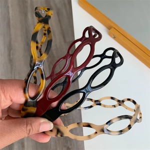 Close-up of four cutout acetate headbands in tortoise shell and leopard prints