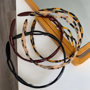 Set of stylish leopard and solid acetate headbands with built-in hair clips for styling