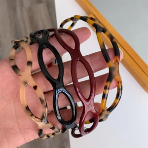 Elegant cutout acetate headbands in four colors featuring geometric leopard pattern