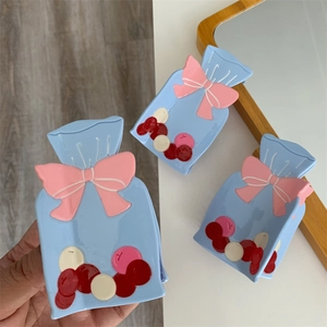 Lot de pinces à cheveux bleu clair avec nœuds roses et motifs de bonbons colorés