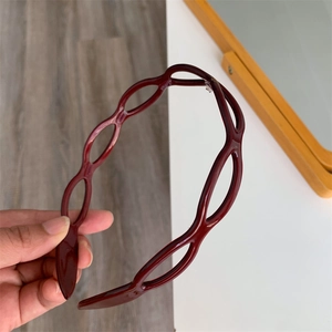Detail of burgundy acetate headband with an oval hollow chain link hollow design