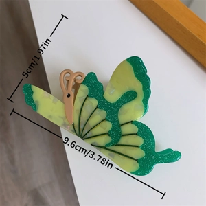 Detail view of 3D butterfly hair claw clip in yellow-green acetate with fine glitter finish