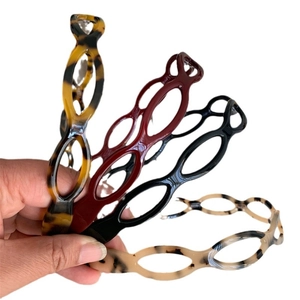 Set of four hollow acetate headbands in tortoiseshell, burgundy, black, and cream colors