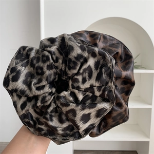 Oversized leopard print faux leather scrunchie with glossy finish and ruched design