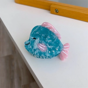 Vue détaillée d'une pince à cheveux baleine bleue en acétate marbré ornée de perles