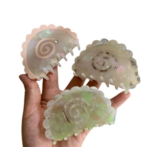 Three-piece acetate shell hair claws with pearlescent finish and scalloped rhinestone edges