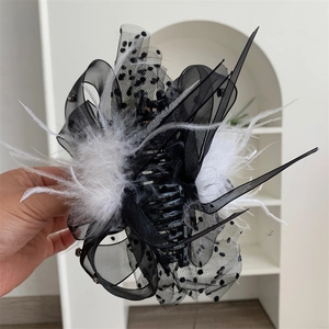 Gothic style large hair claw clip with black lace polka dots, bow, and white feathers