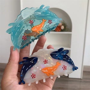 Detail of whale pattern hair claws in translucent blue and iridescent pearl acetate