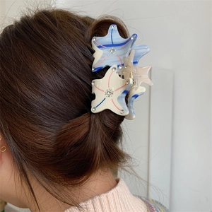 Starfish hair claw clip with rhinestones shown on hair for an elegant look