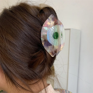 Pince à cheveux œil holographique en acétate avec un design de pupille verte unique