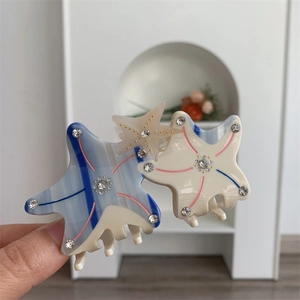 Detail of starfish hair claw clip with acetate patterns and sparkling rhinestones
