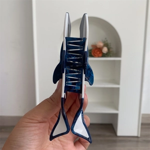 Detail of the shark hair claw showing blue and white marble acetate material